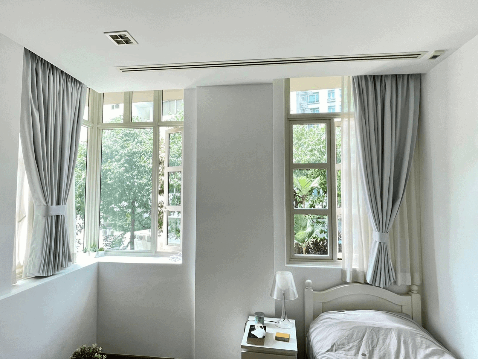 Condo bedroom bay window day night curtains grey